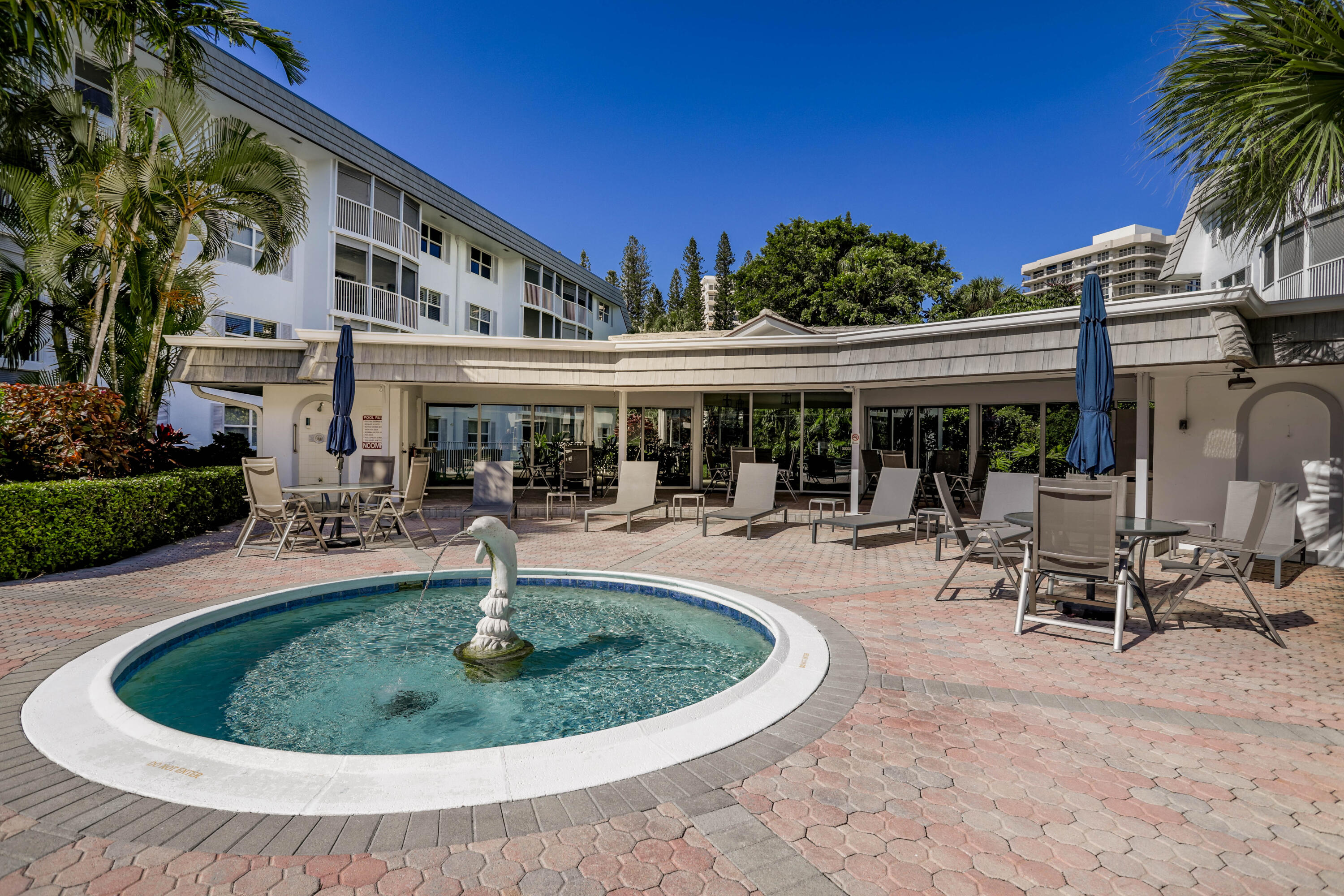 800 East Camino Real, Unit 204 Boca Raton, FL 33432 - Photo 30 of 39 a view of a house with swimming pool and sitting area