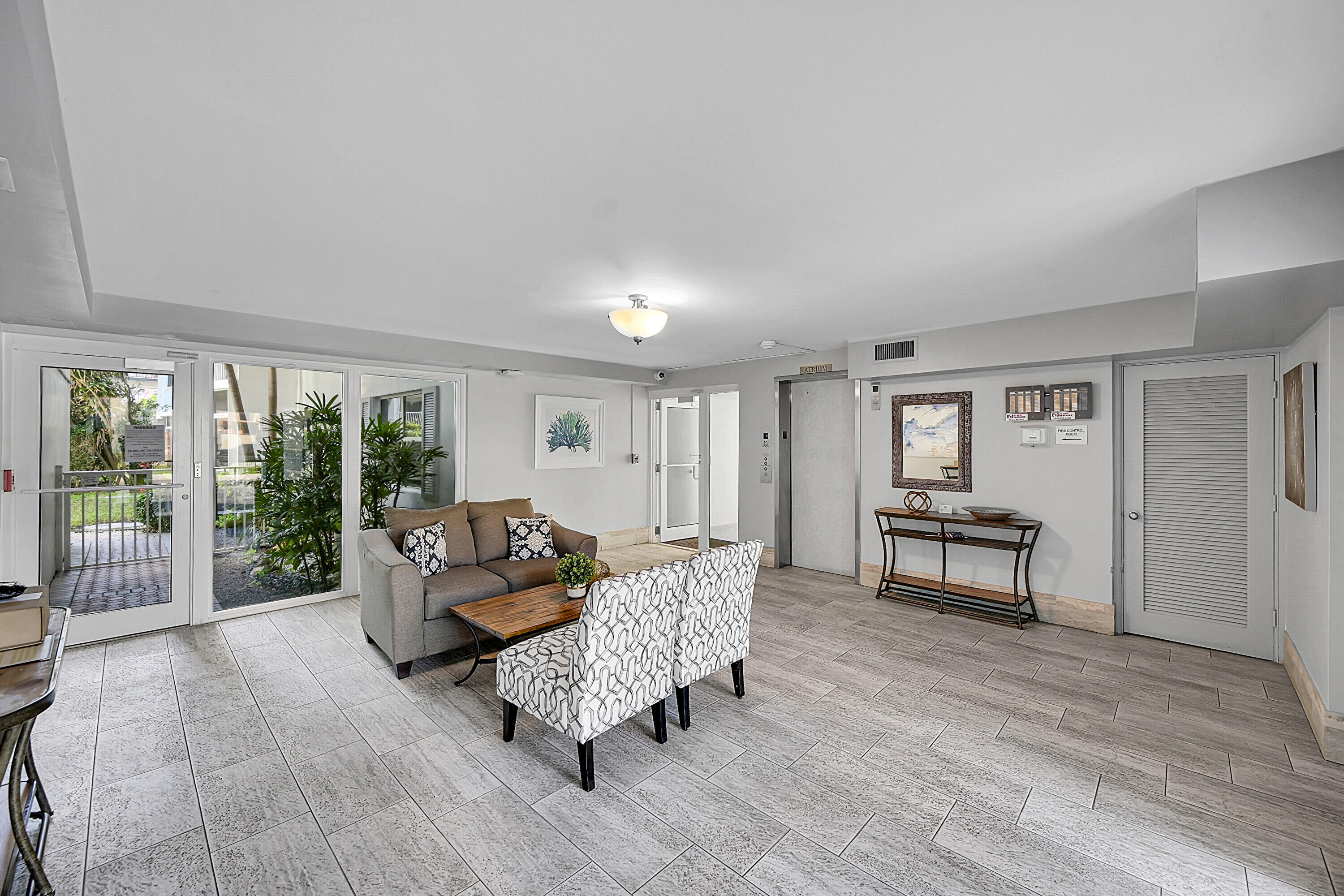 800 East Camino Real, Unit 204 Boca Raton, FL 33432 - Photo 3 of 39 a living room with furniture and a wooden floor