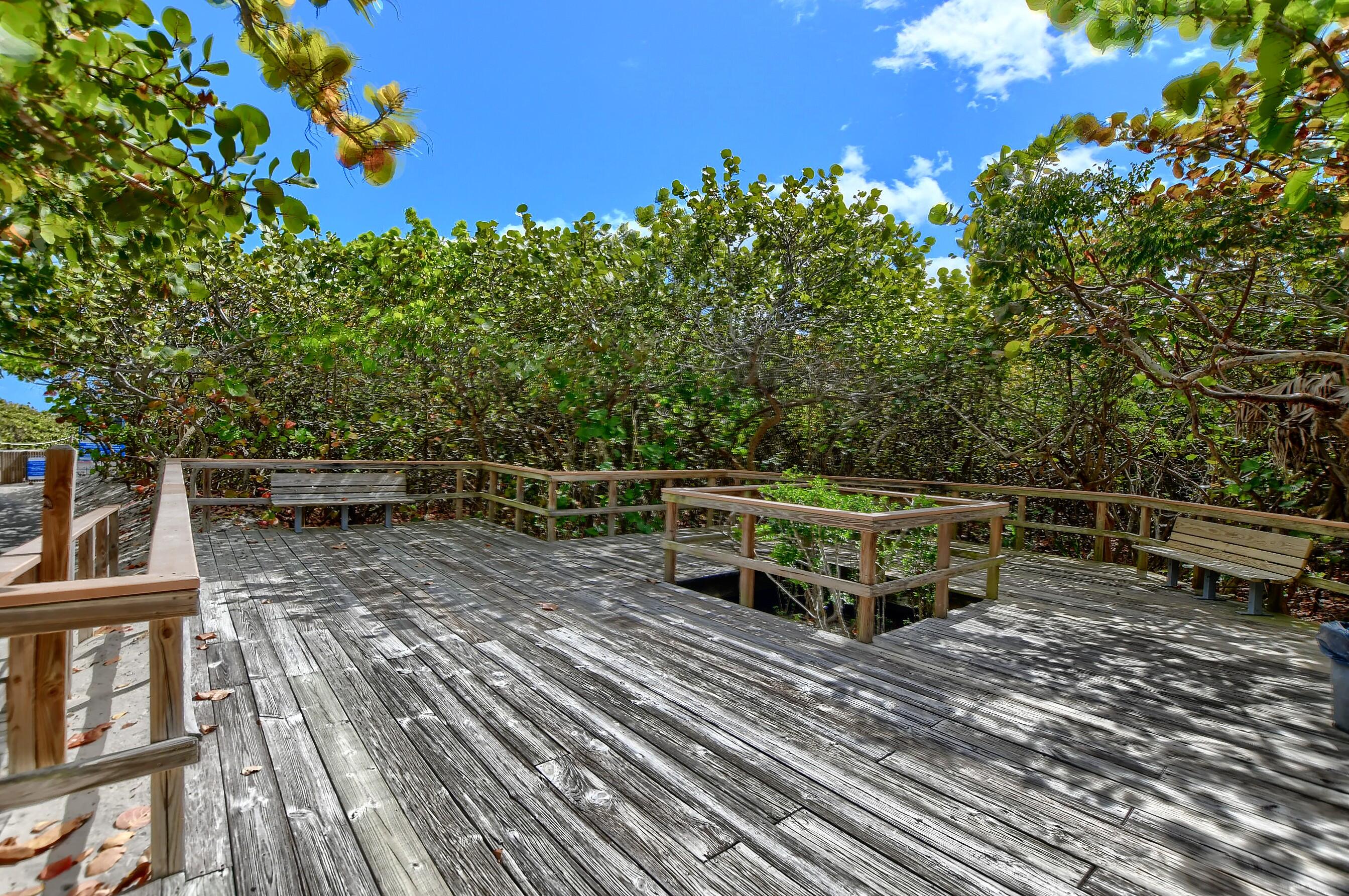 800 East Camino Real, Unit 204 Boca Raton, FL 33432 - Photo 33 of 39 a view of a chairs and table on the wooden floor