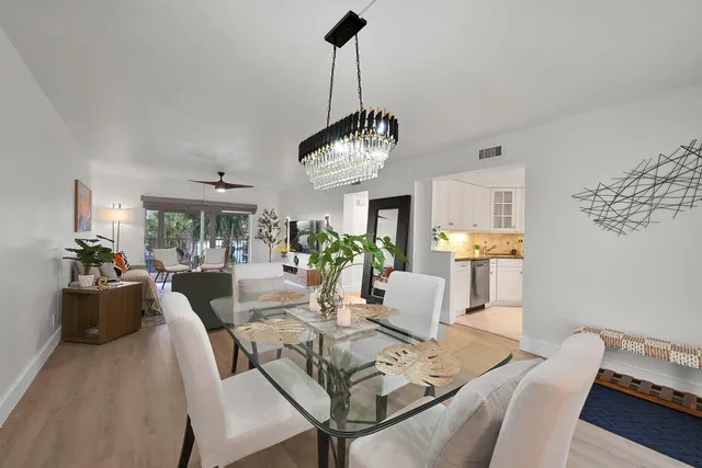 a view of a dining room with furniture wooden floor and chandelier