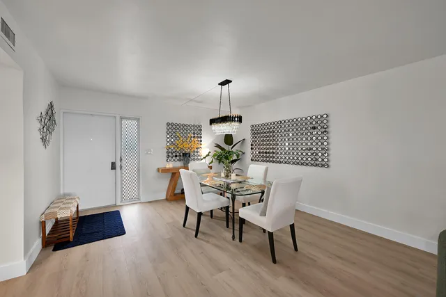 a dining room with furniture and wooden floor