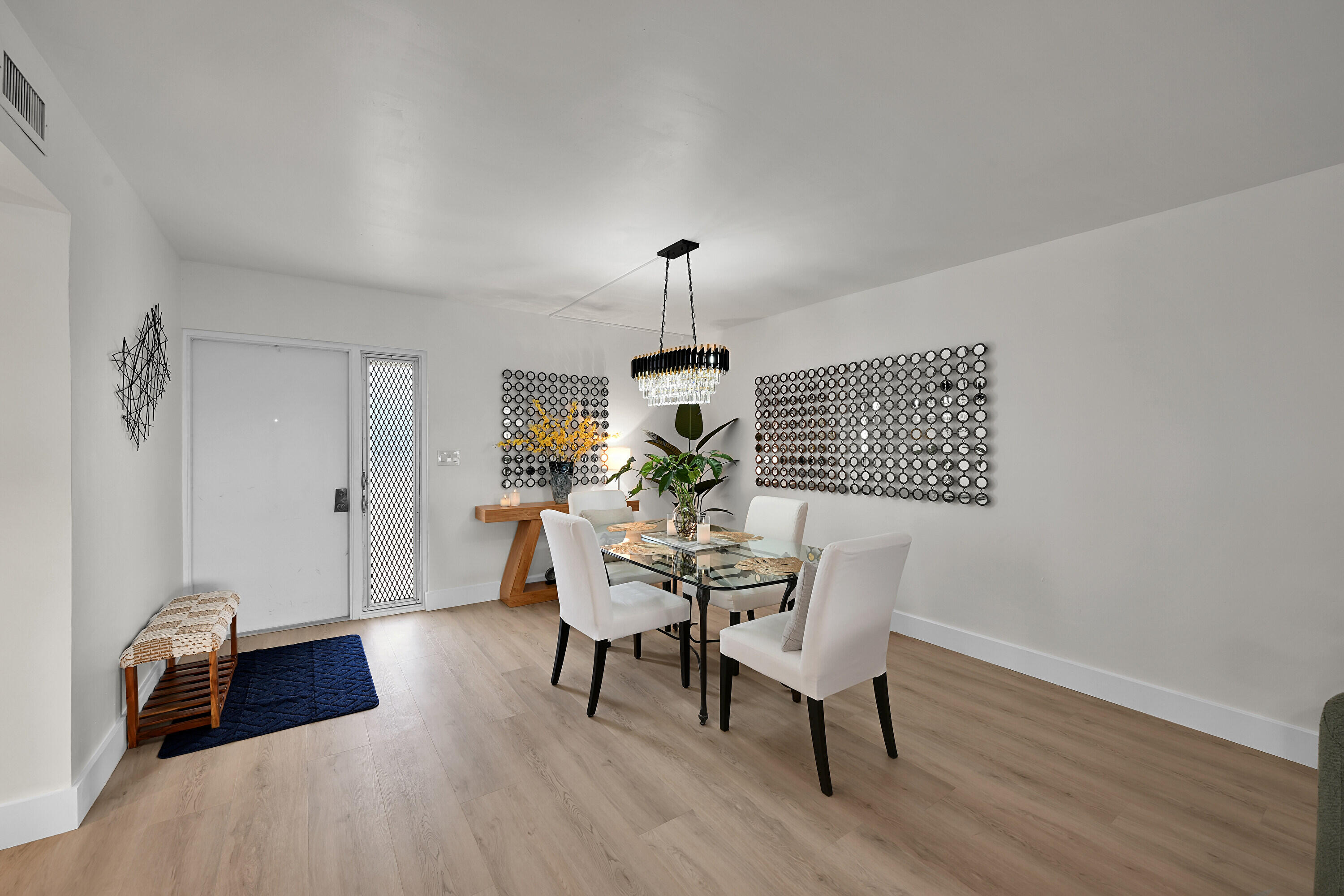 800 East Camino Real, Unit 204 Boca Raton, FL 33432 - Photo 9 of 39 a dining room with furniture and wooden floor