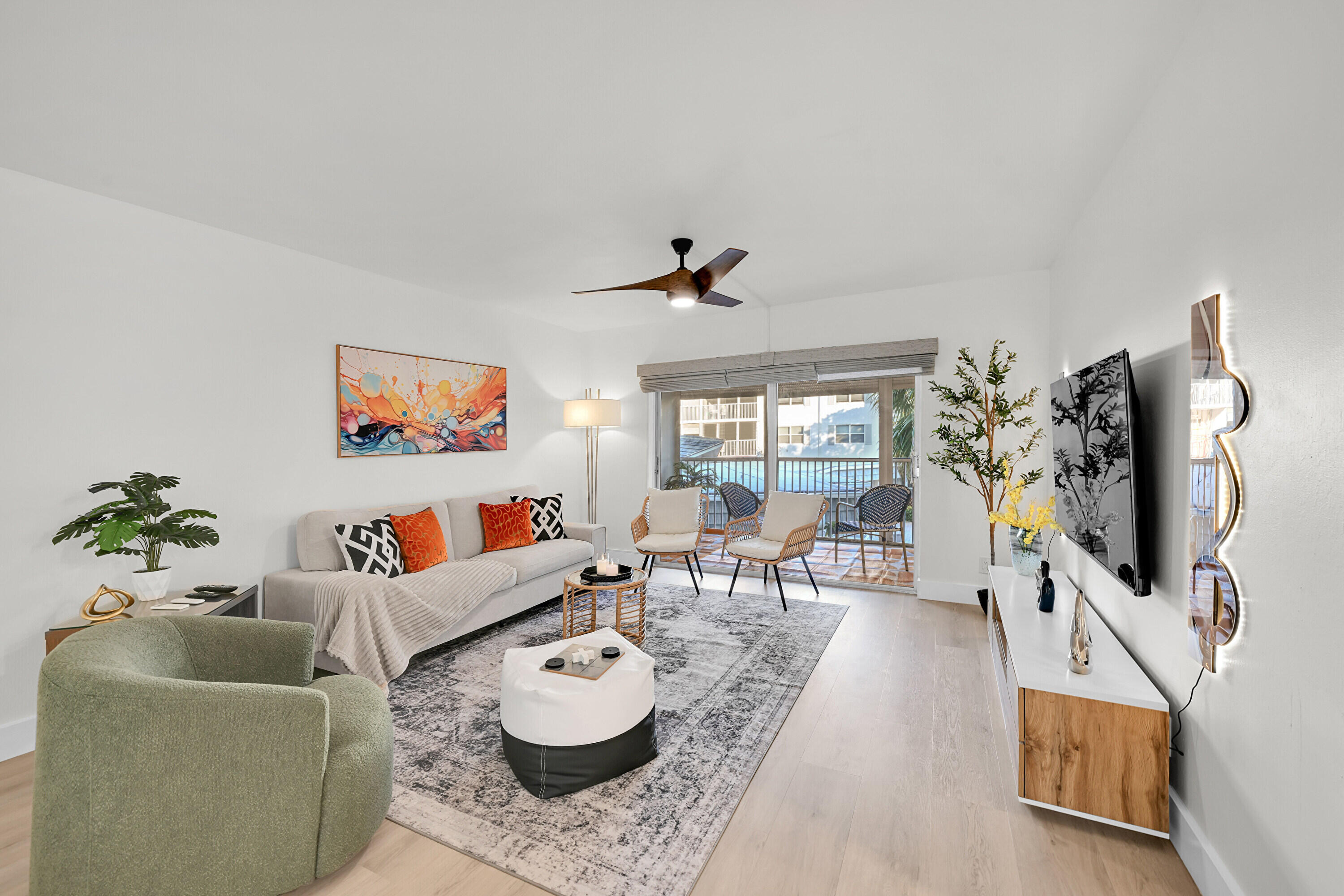 800 East Camino Real, Unit 204 Boca Raton, FL 33432 - Photo 10 of 39 a living room with furniture and a flat screen tv