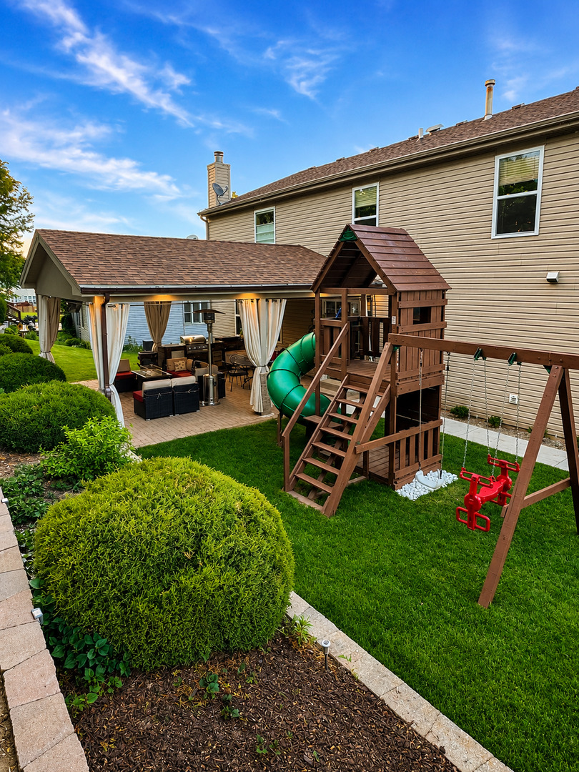 720 Ridge Drive Marengo, IL 60152 - Photo 31 of 34 a view of a house with backyard sitting area and garden
