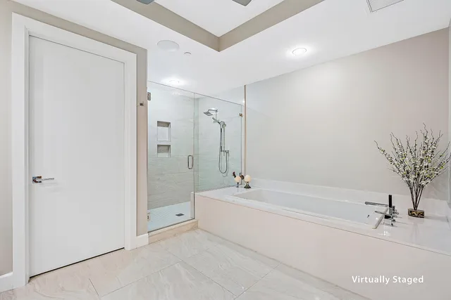 a spacious bathroom with a tub shower and a sink