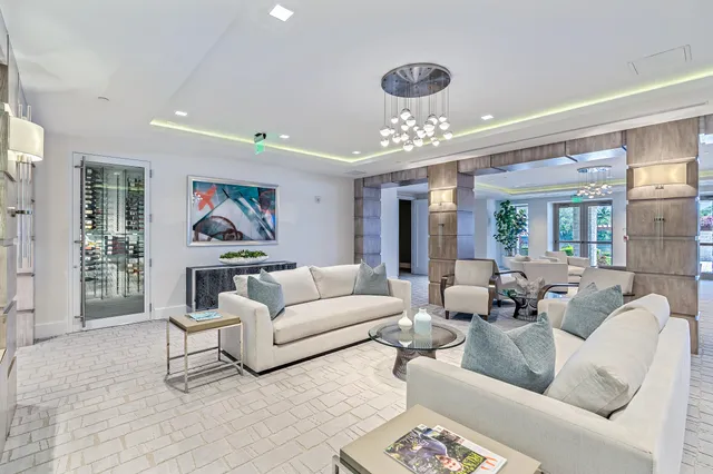 a living room with furniture and a chandelier
