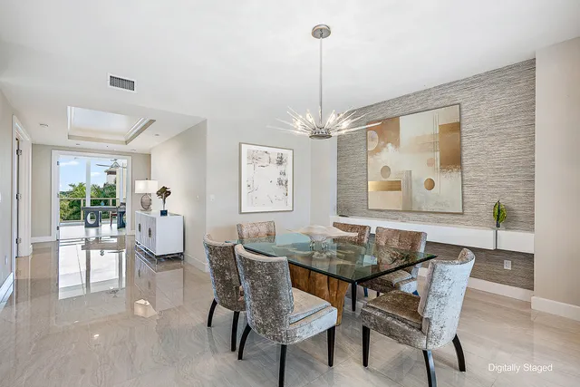 a dining room with furniture a chandelier and wooden floor