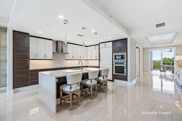 a kitchen with cabinets and chairs in it