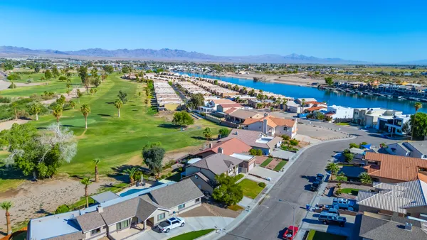 a view of a room with a ceiling fan and window