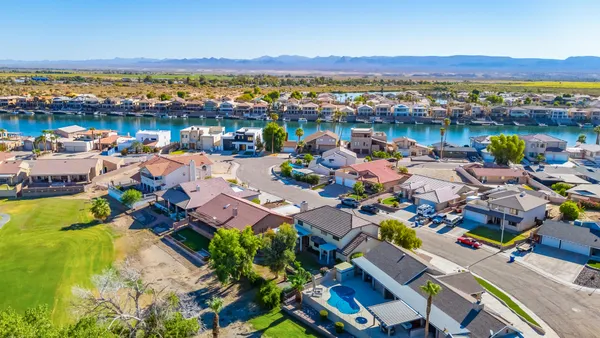 an empty room with a ceiling fan and a window