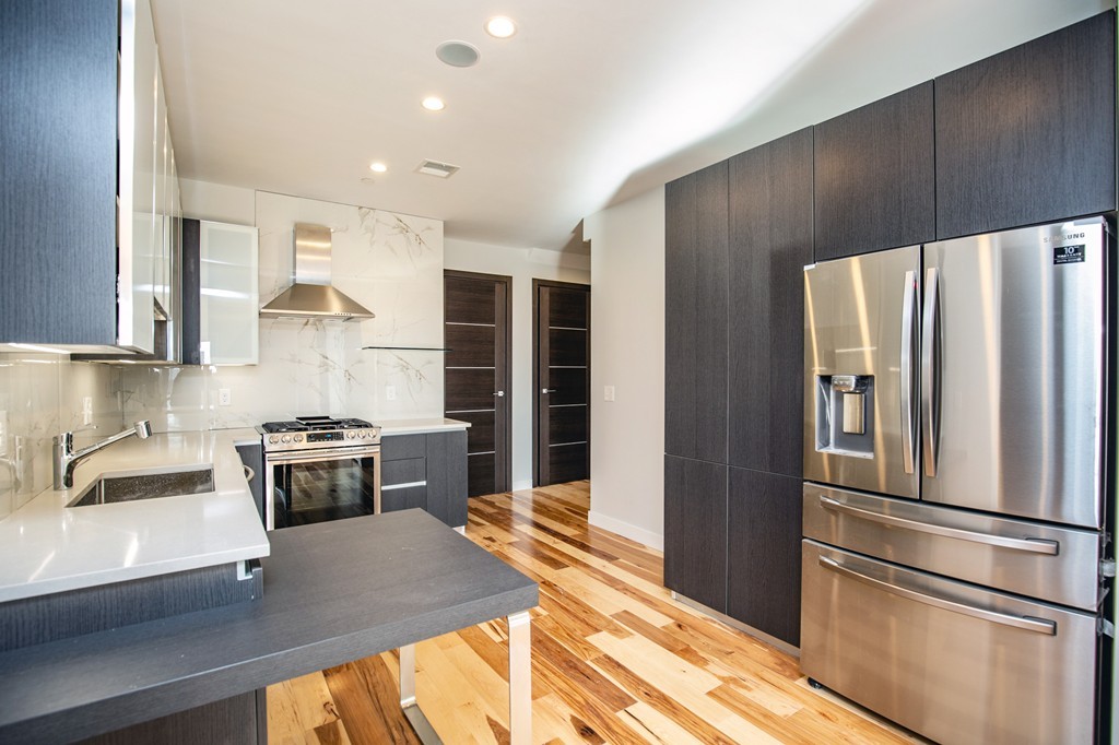39 Lexington Street, Unit 9 Boston, MA 02128 - Photo 2 of 10 a kitchen with stainless steel appliances a refrigerator sink and stove