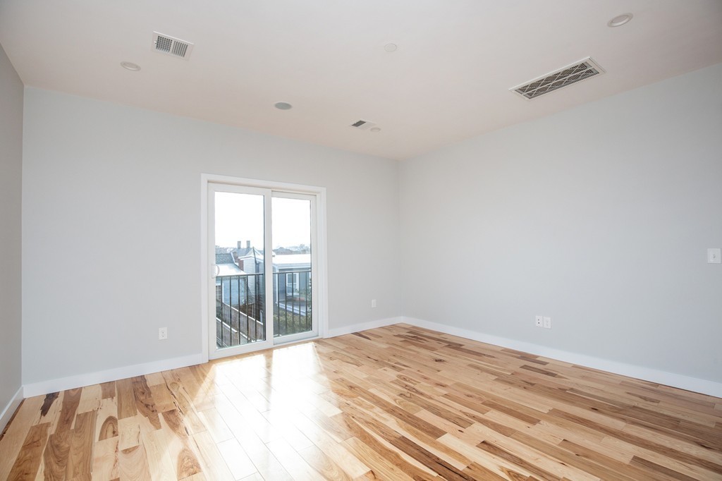 39 Lexington Street, Unit 9 Boston, MA 02128 - Photo 4 of 10 a view of a room with wooden floor and white walls