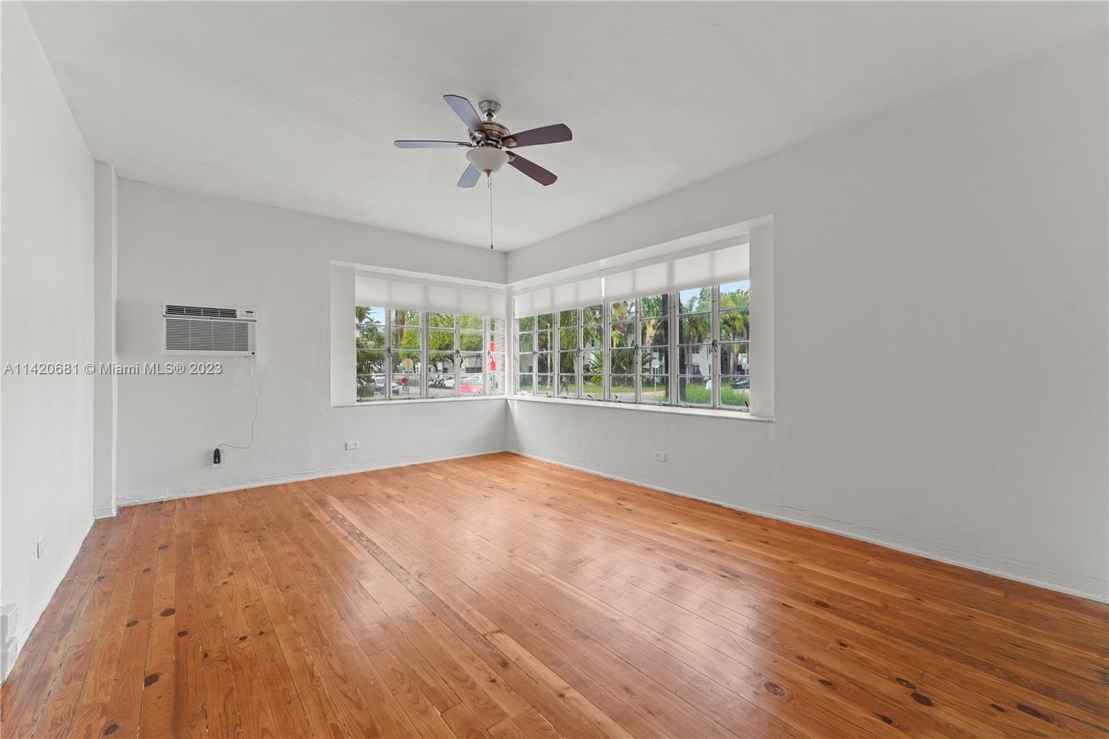 531 16th Street Miami Beach, FL 33139 - Photo 15 of 26 a view of an empty room with wooden floor and a window