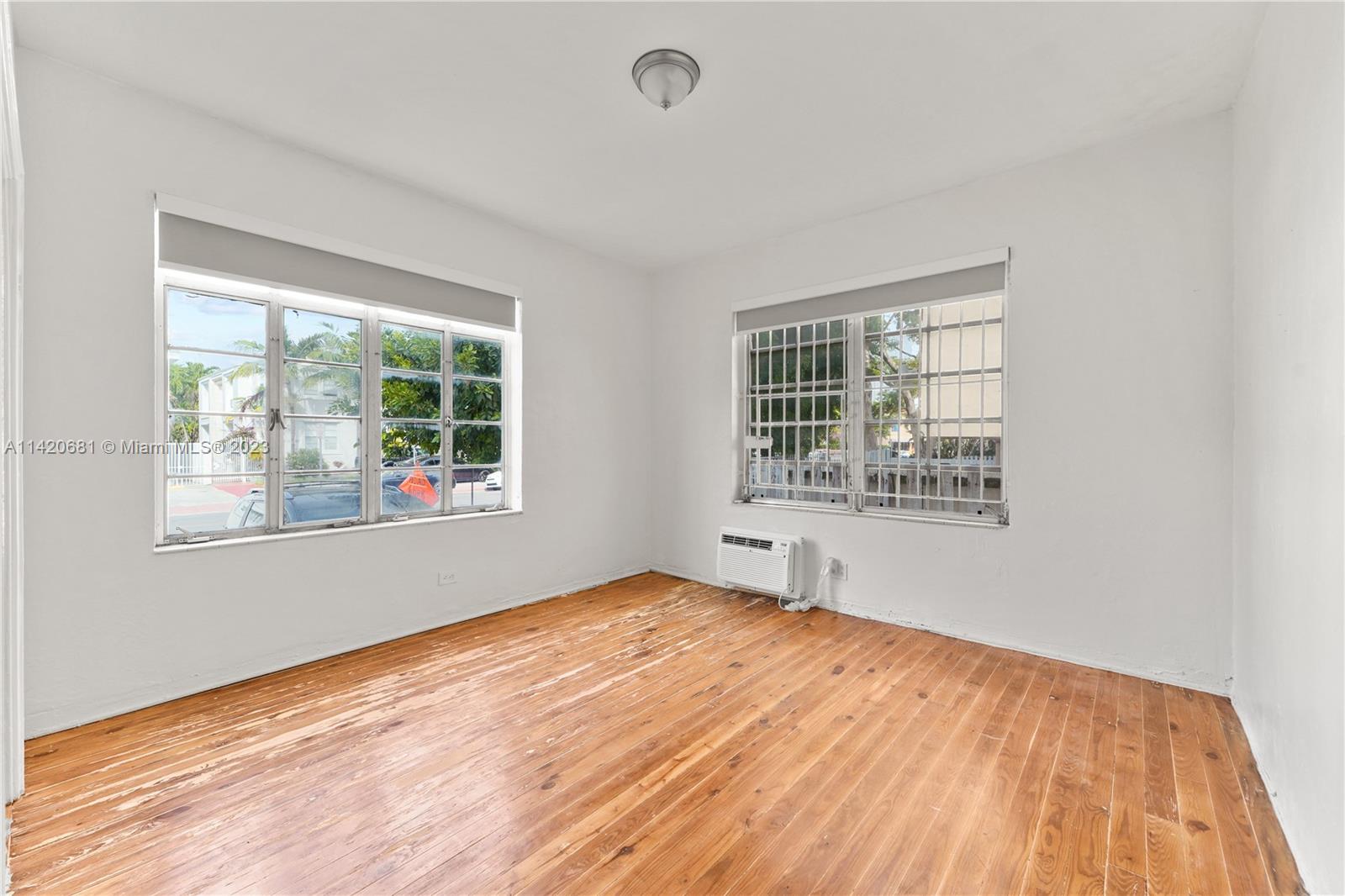 531 16th Street Miami Beach, FL 33139 - Photo 17 of 26 a view of an empty room with wooden floor and a window