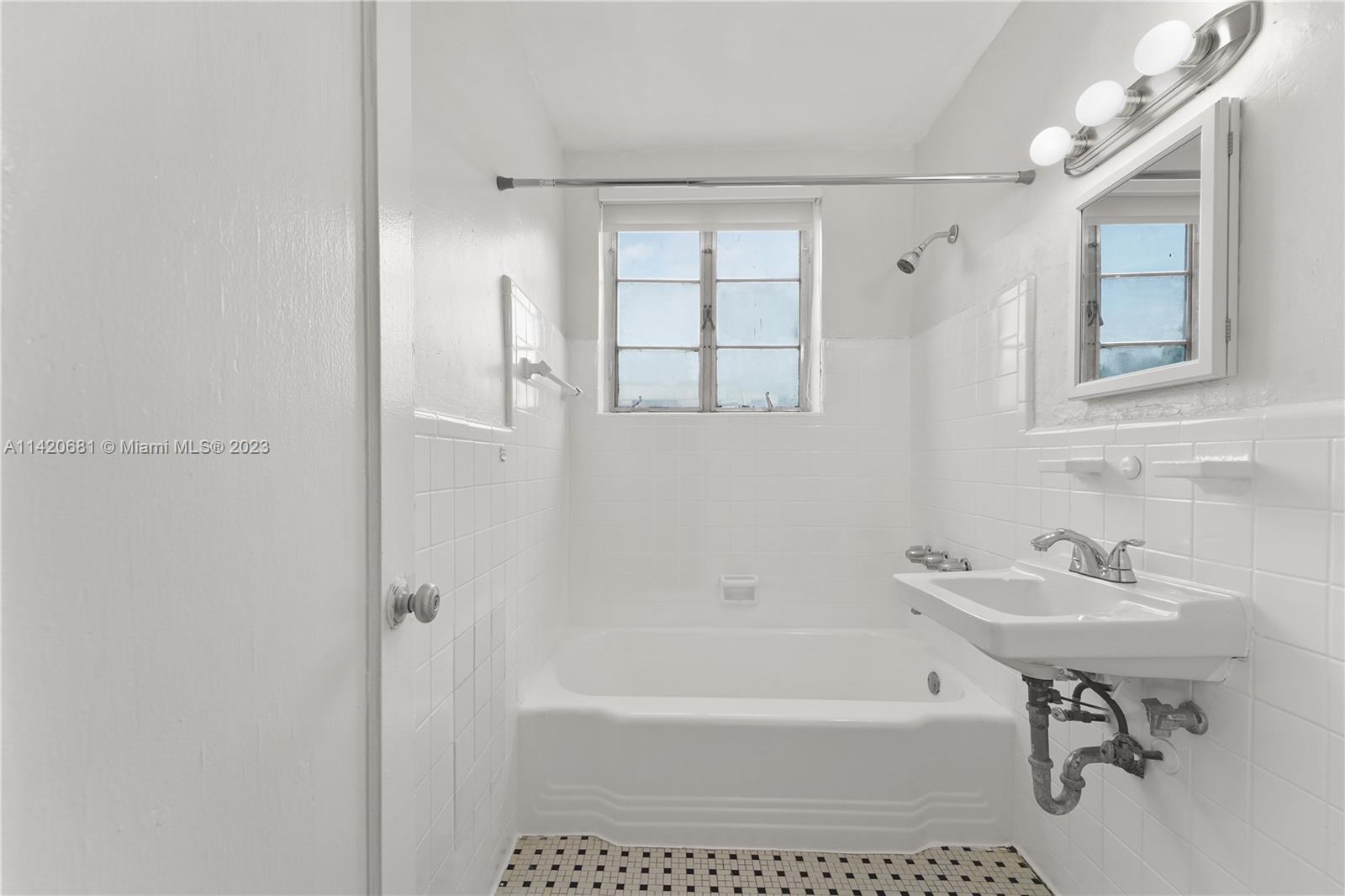 531 16th Street Miami Beach, FL 33139 - Photo 23 of 26 a white bath tub sitting next to a white sink