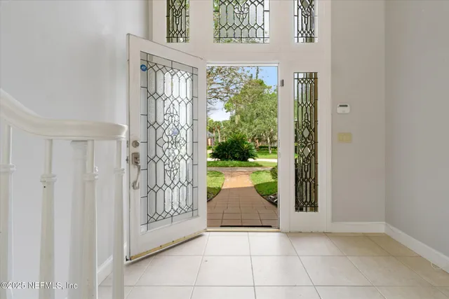 a living room with furniture floor to ceiling window and wooden floor