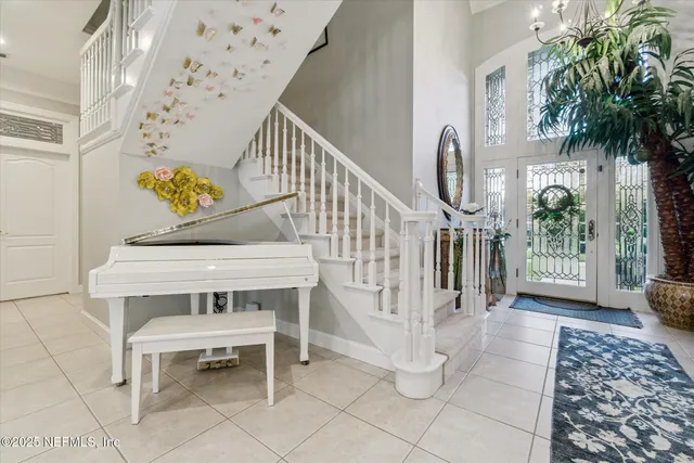 a living room with a flat screen tv and a floor to ceiling window