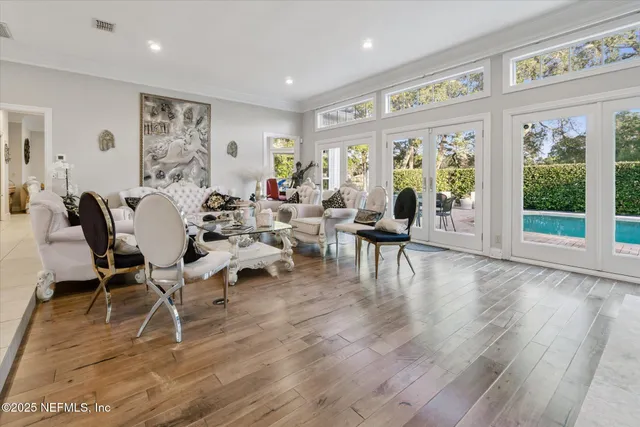 a view of empty room with wooden floor and windows