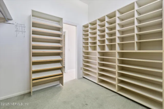 an empty room with a ceiling fan and window