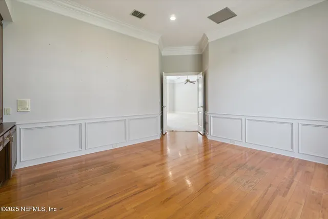 a view of a house with a big yard and large trees