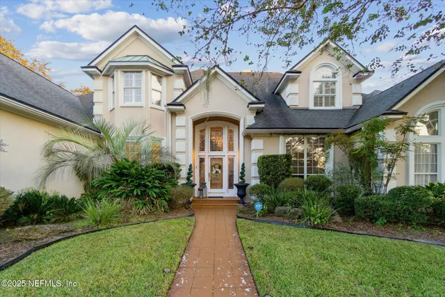 a front view of a house with a yard and a garage