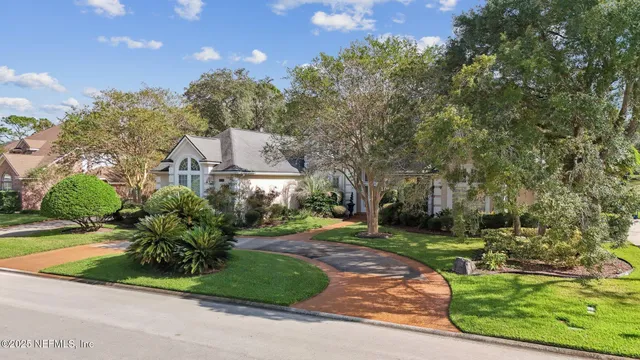 a front view of house with a garden and patio