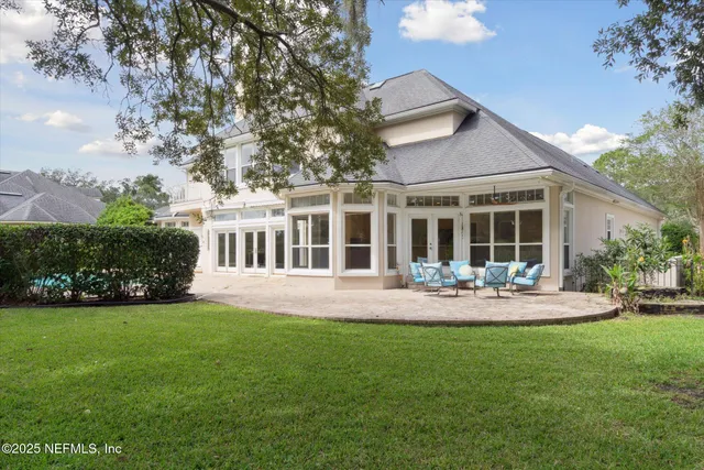 a front view of a house with sitting area and garden
