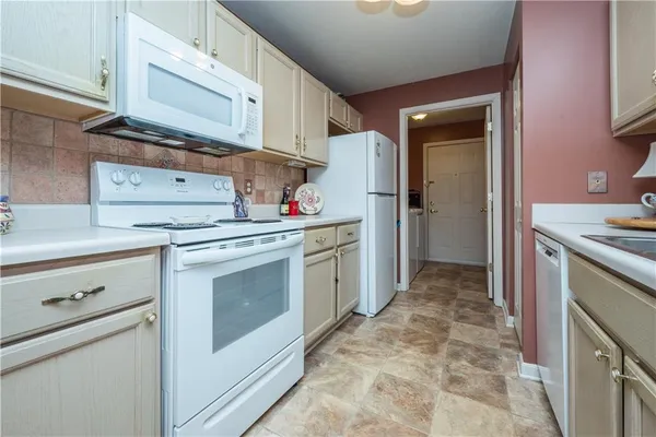 a kitchen with a stove sink and refrigerator