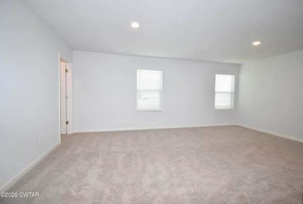 an empty room with windows and closet