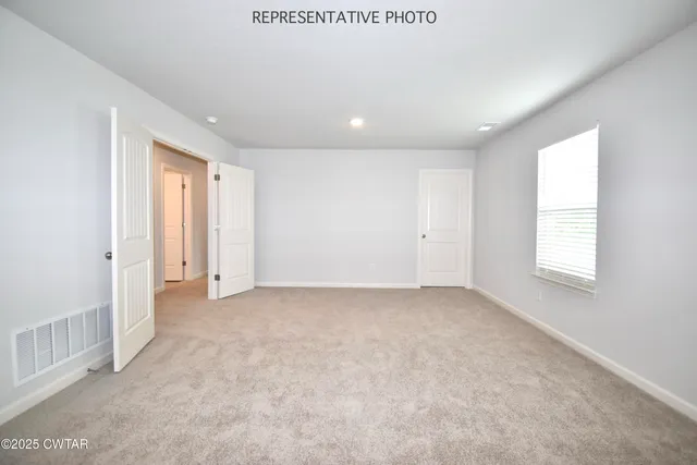 an empty room with windows and closet