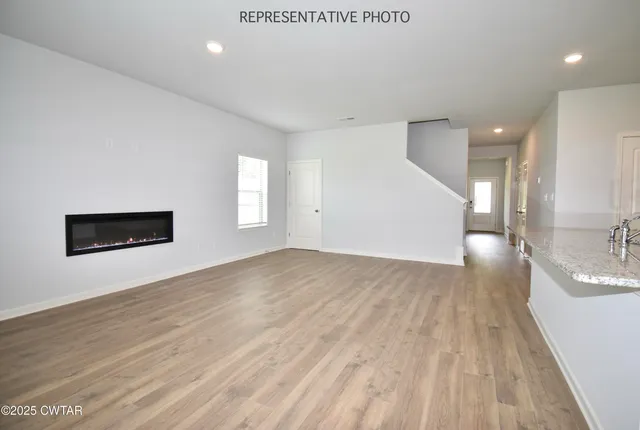 a view of a kitchen with a sink and a large window