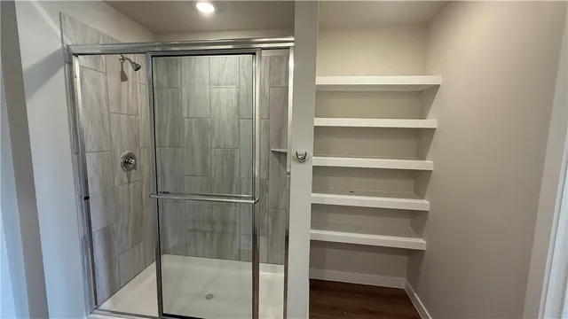 a bathroom with a glass shower door