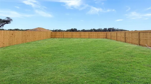 a view of a lake with houses in the back
