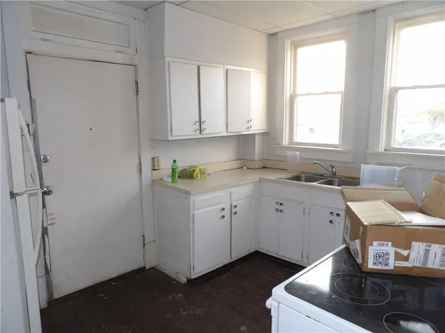 a view of cabinets a sink and a window in a room