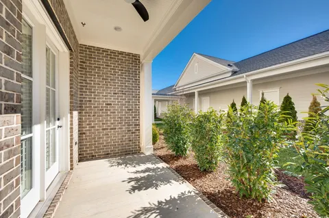 a front view of a house with garden and porch
