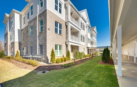a view of a lake with houses in the back