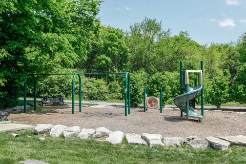 a view of a house with backyard sitting area and garden