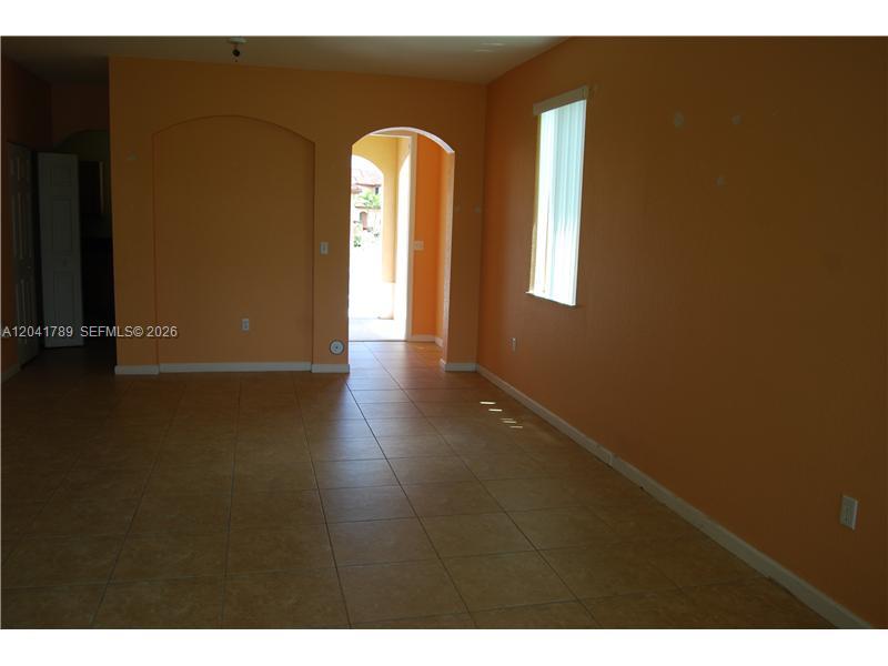 12080 Southwest 268th Street, Unit 24 Homestead, FL 33032 - Photo 4 of 29 a view of empty room with wooden floor