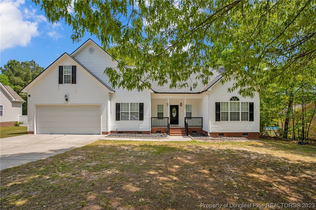 369 Grand Stand Lane Angier, NC 27501 - Photo 1 of 33 a front view of house with yard and trees in the background
