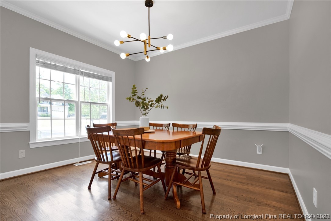369 Grand Stand Lane Angier, NC 27501 - Photo 13 of 33 a view of a dining room with furniture window and wooden floor