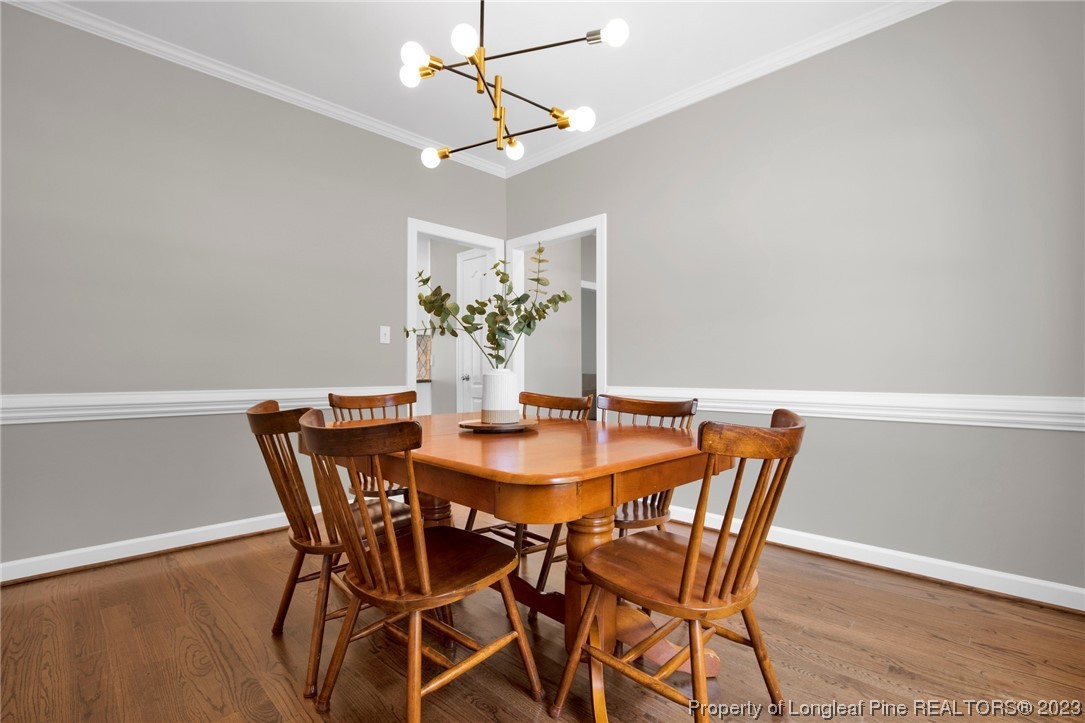 369 Grand Stand Lane Angier, NC 27501 - Photo 14 of 33 a view of a dining room with furniture and wooden floor
