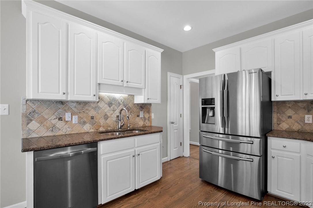 369 Grand Stand Lane Angier, NC 27501 - Photo 16 of 33 a kitchen with stainless steel appliances granite countertop a refrigerator sink and cabinets