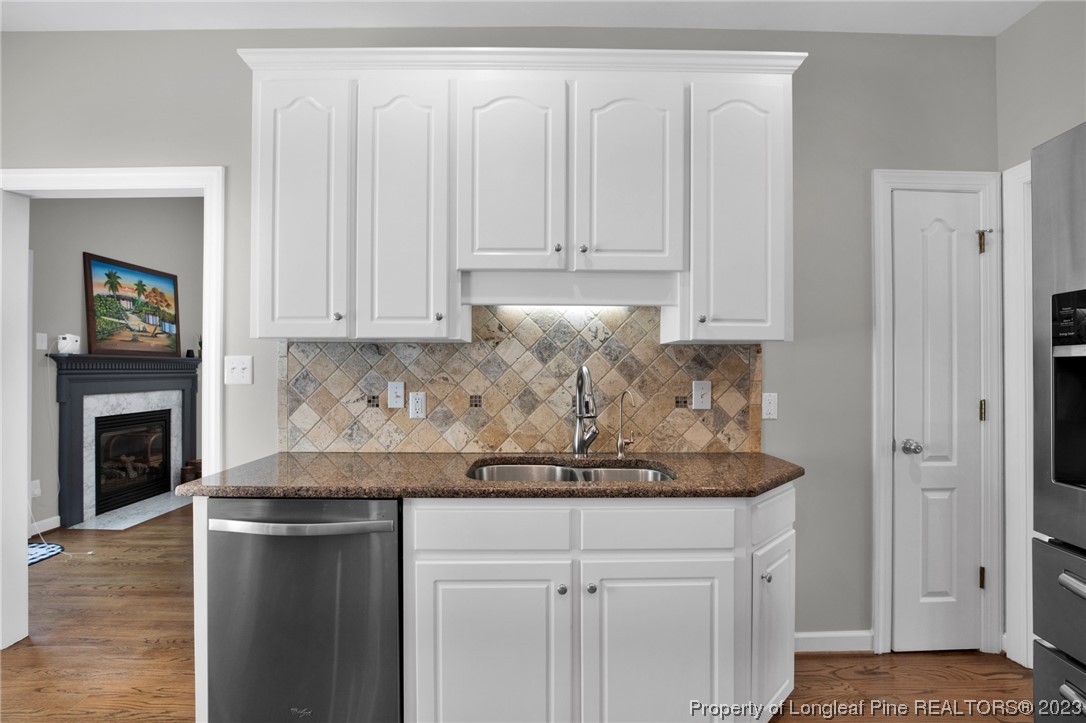369 Grand Stand Lane Angier, NC 27501 - Photo 17 of 33 a kitchen with stainless steel appliances granite countertop a stove a refrigerator and a white cabinets