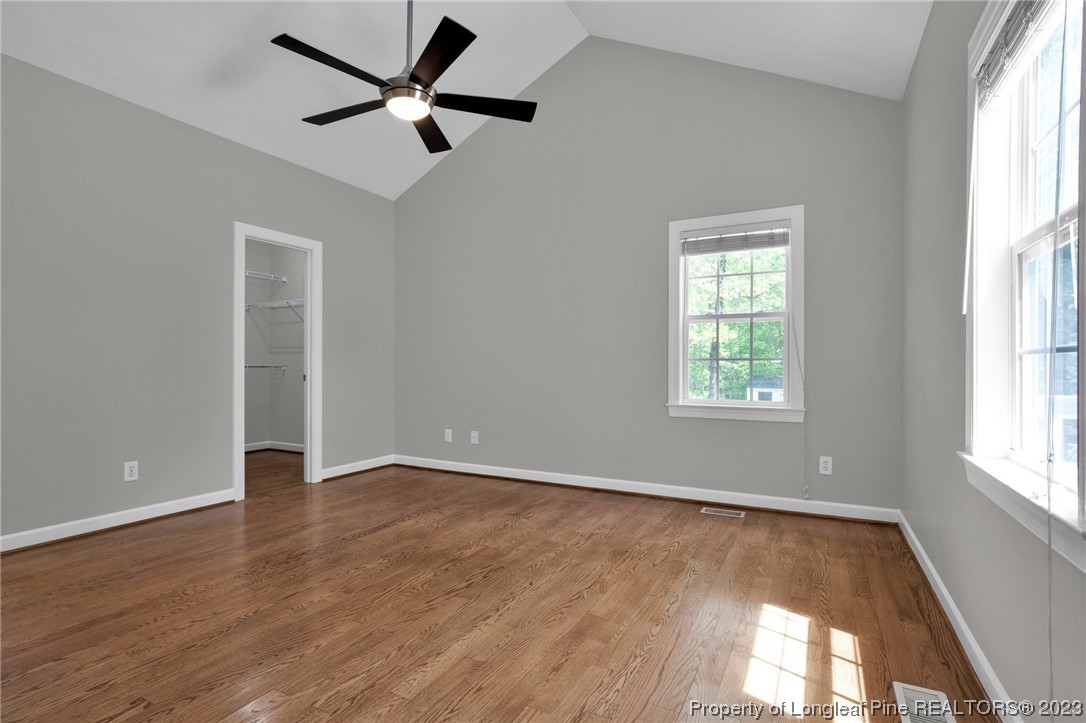 369 Grand Stand Lane Angier, NC 27501 - Photo 19 of 33 an empty room with wooden floor fan and windows