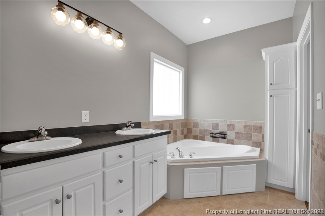 369 Grand Stand Lane Angier, NC 27501 - Photo 23 of 33 a bathroom with a granite countertop sink and a mirror