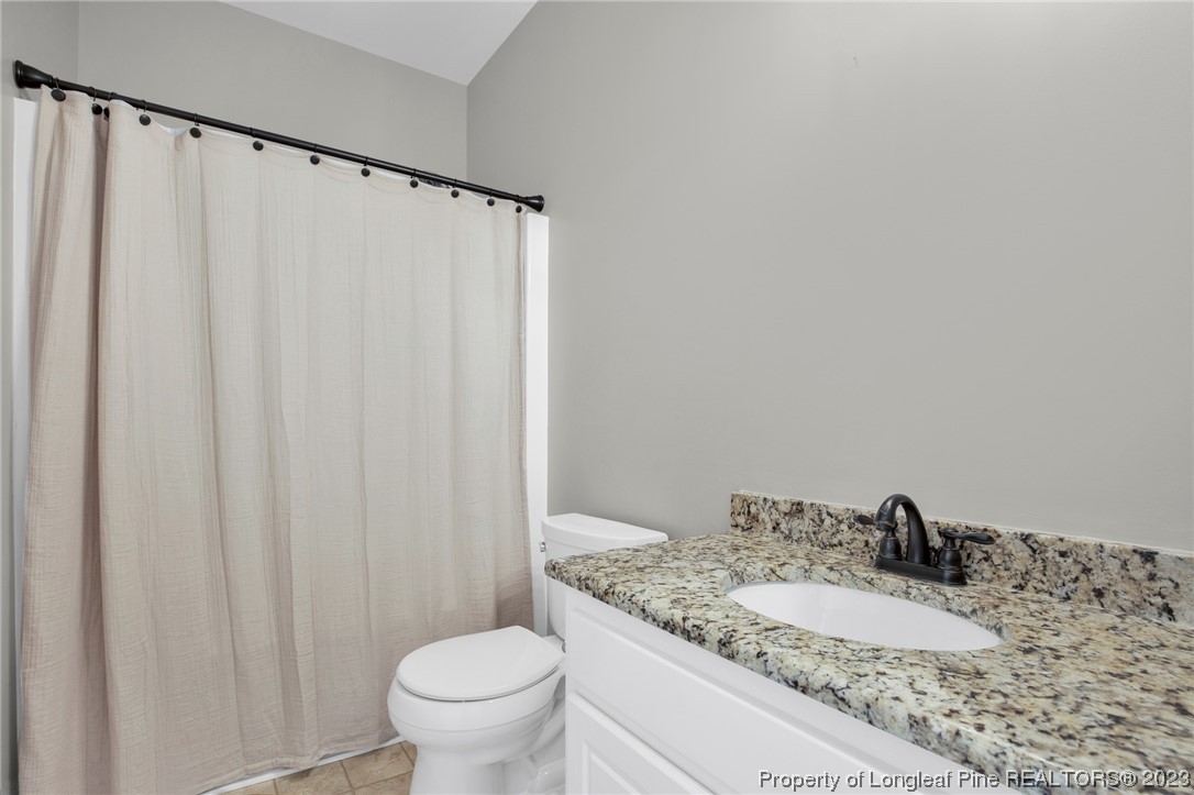 369 Grand Stand Lane Angier, NC 27501 - Photo 26 of 33 a bathroom with a granite countertop sink and a mirror
