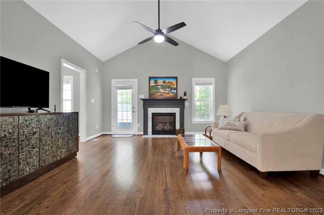 369 Grand Stand Lane Angier, NC 27501 - Photo 3 of 33 a living room with furniture a flat screen tv and a fireplace