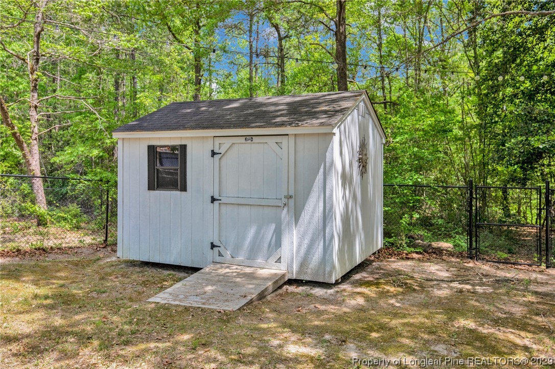 369 Grand Stand Lane Angier, NC 27501 - Photo 31 of 33 a backyard of a house with large trees