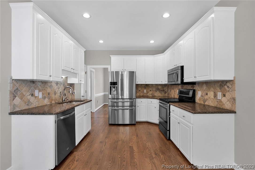 369 Grand Stand Lane Angier, NC 27501 - Photo 4 of 33 a large kitchen with stainless steel appliances granite countertop a stove a sink and a refrigerator