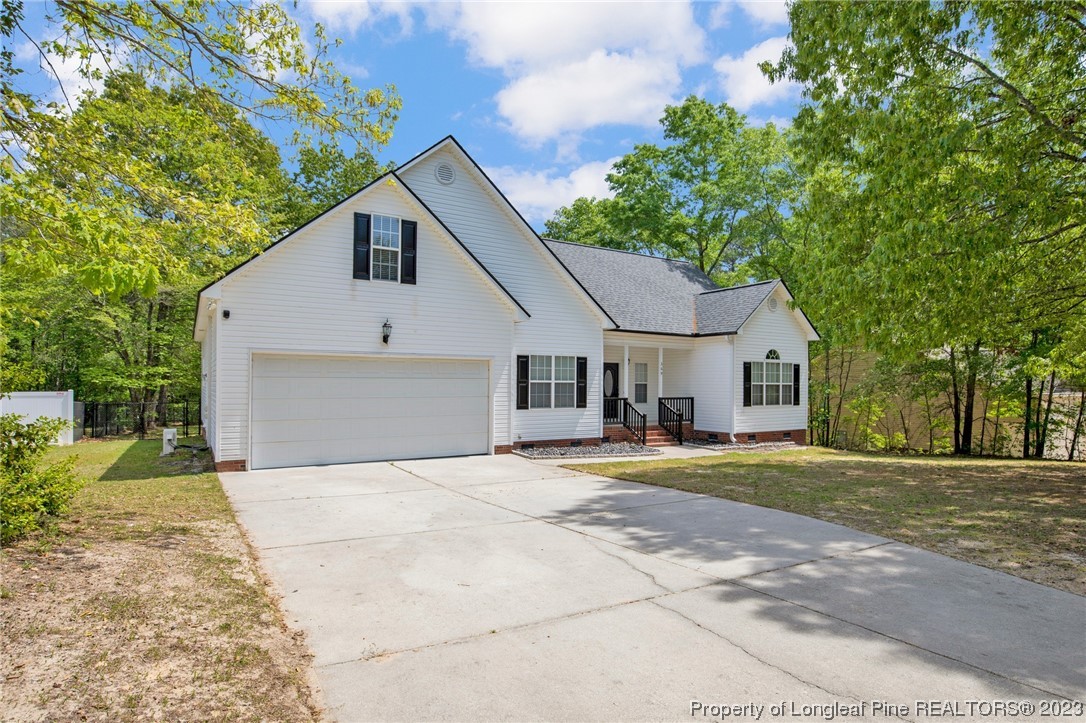 369 Grand Stand Lane Angier, NC 27501 - Photo 5 of 33 a front view of a house with a yard and trees